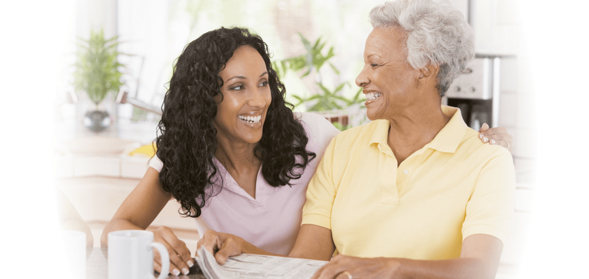 a lady and an old woman smiling at each other